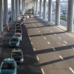 What does the ban and un-ban of online car-hailing services at Pudong Airport signify?